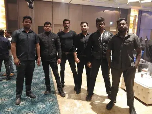 Team of bouncers in black uniforms at an event venue